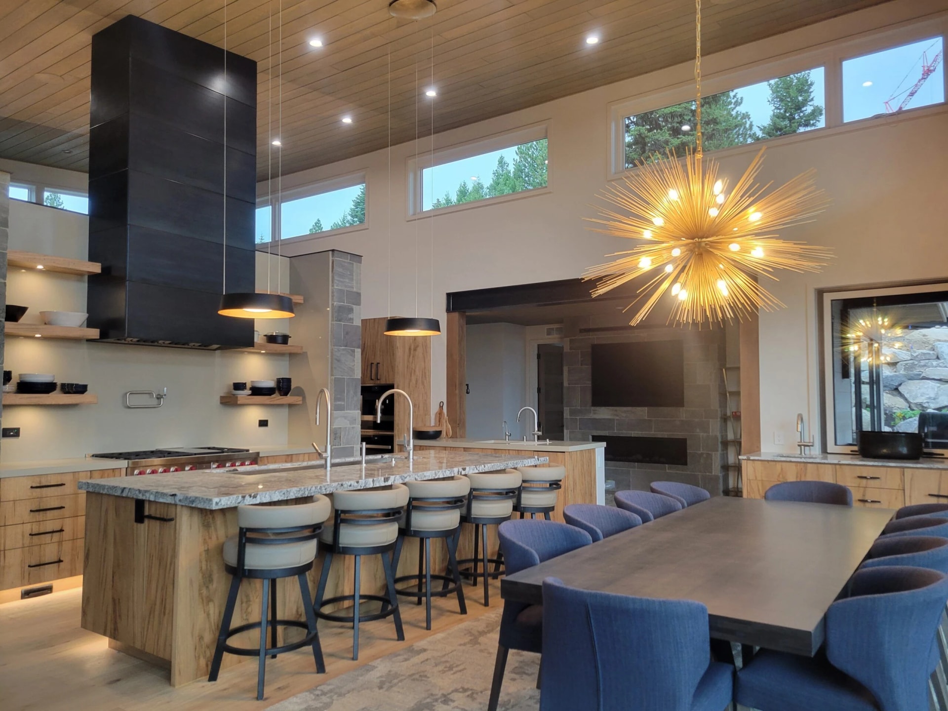 custom black metal range hood and structural steel beam luxury kitchen