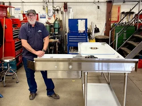custom stainless steel commercial sink and prep table in fabrication shop