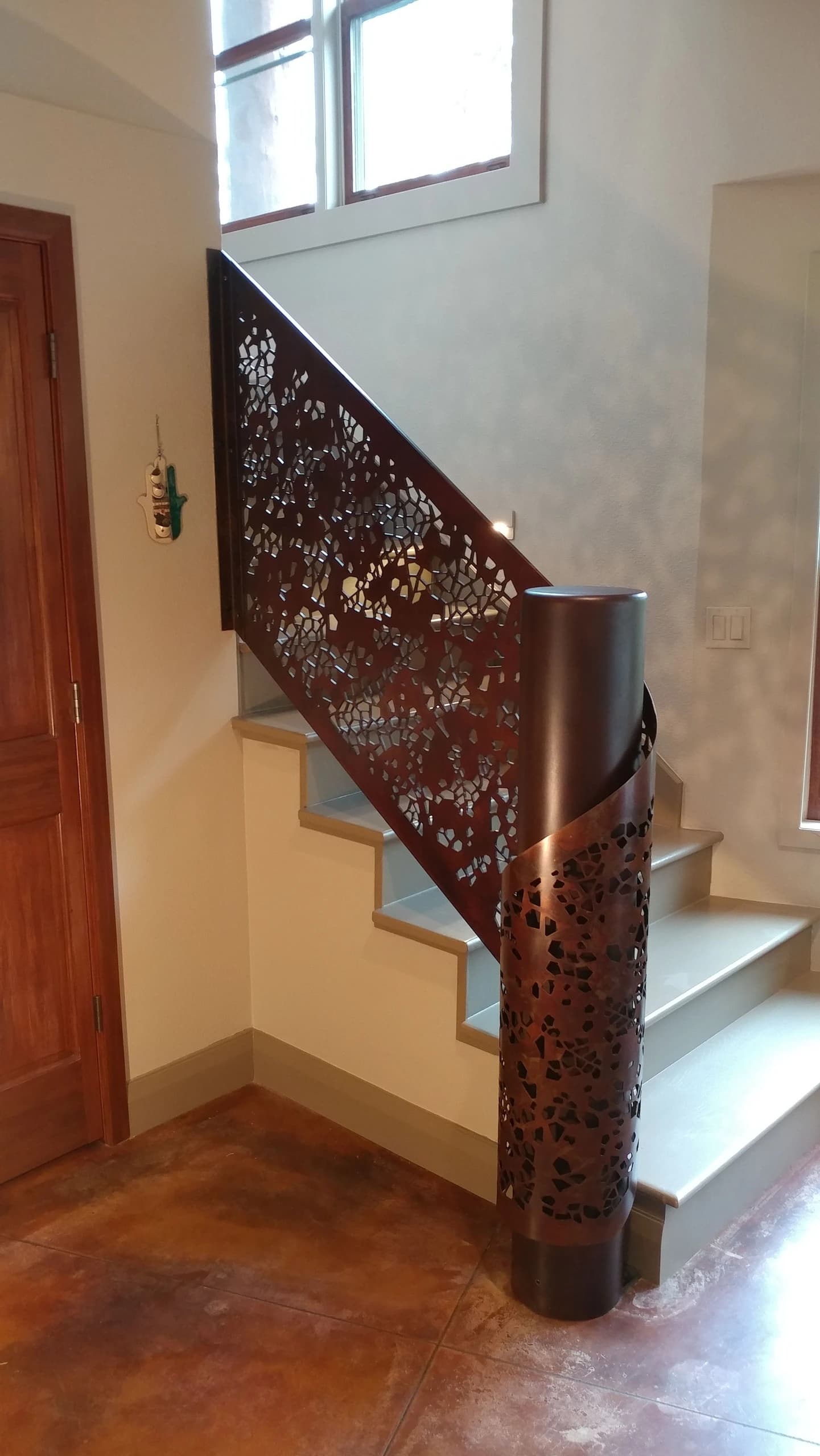 laser cut ornamental metal stair railing with bronze newel post