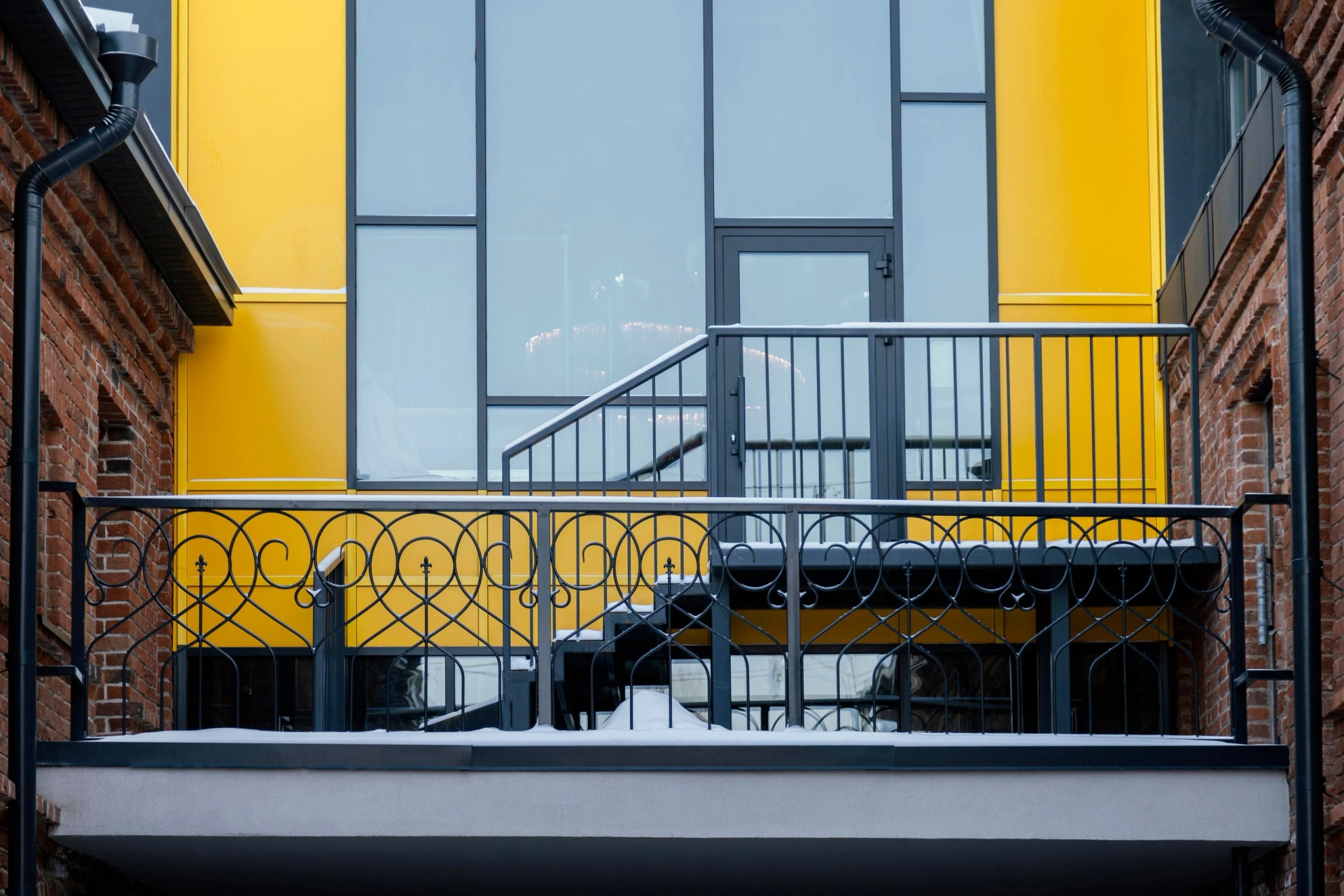 ornamental black metal balcony railings and exterior structural steel stairs